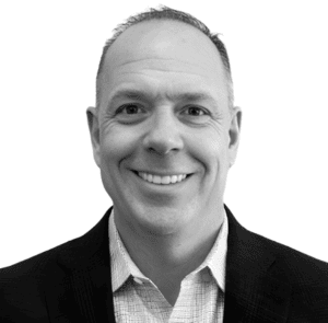 Professional man smiling in business attire.