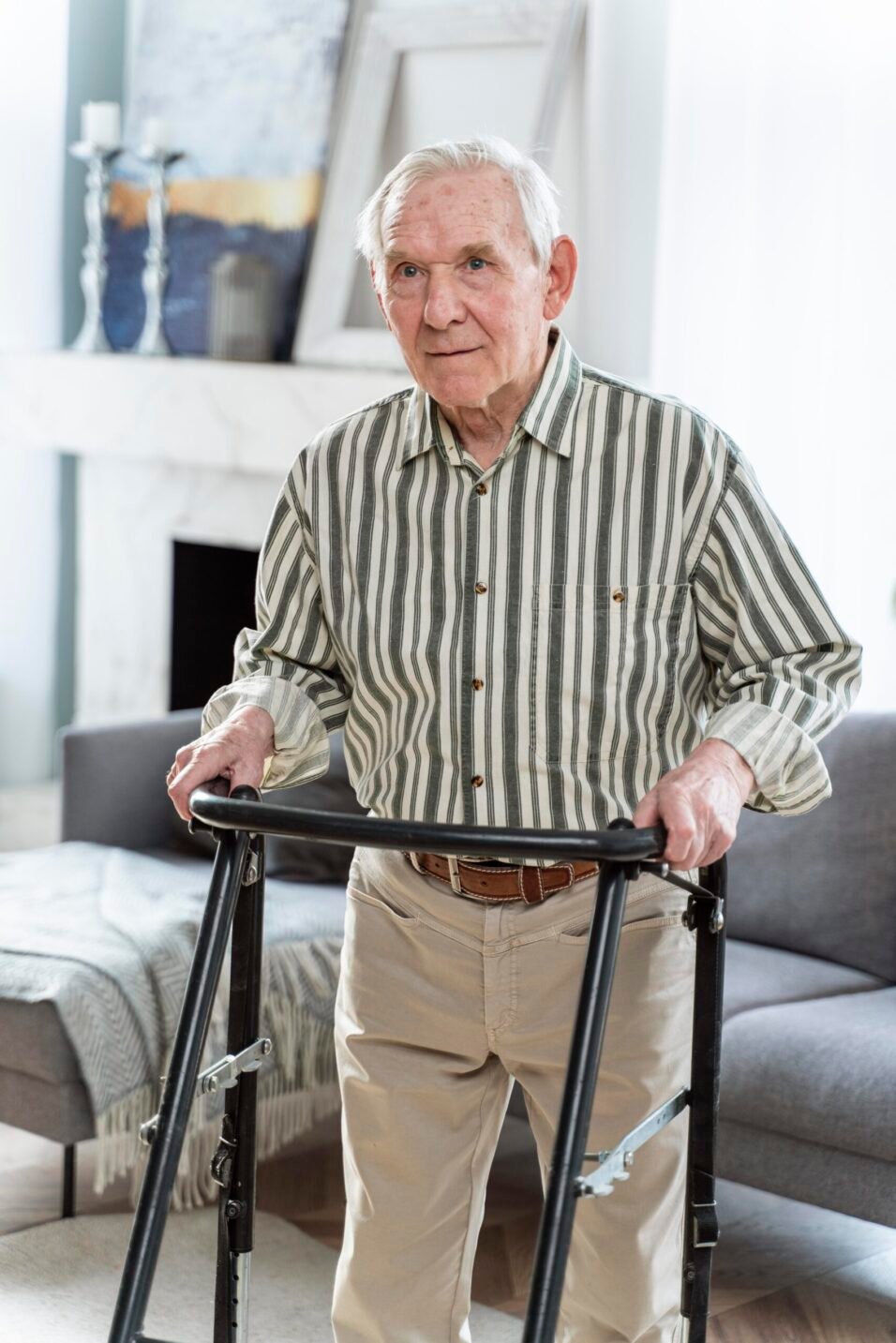 Walking aid for elderly man using a walker in a cozy living room.