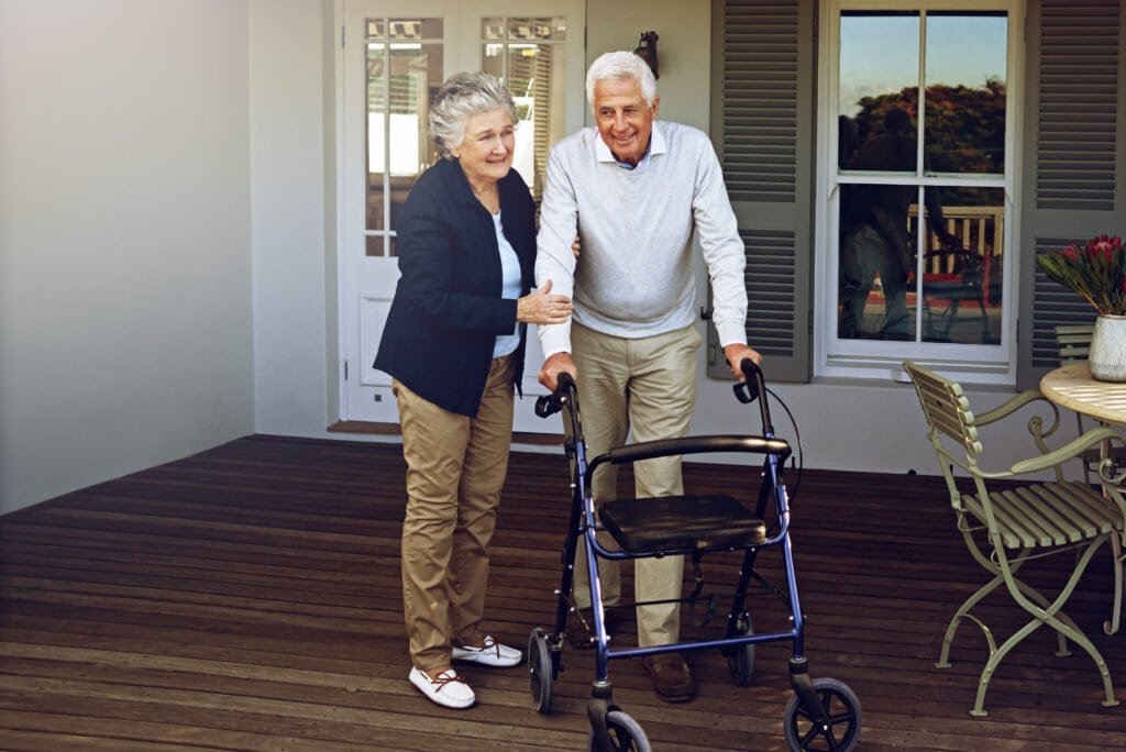 Walking therapy for stroke recovery on a porch.