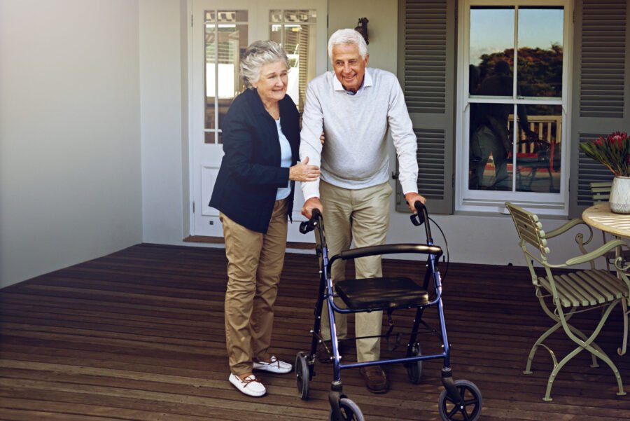 Walking therapy for stroke recovery on a porch.