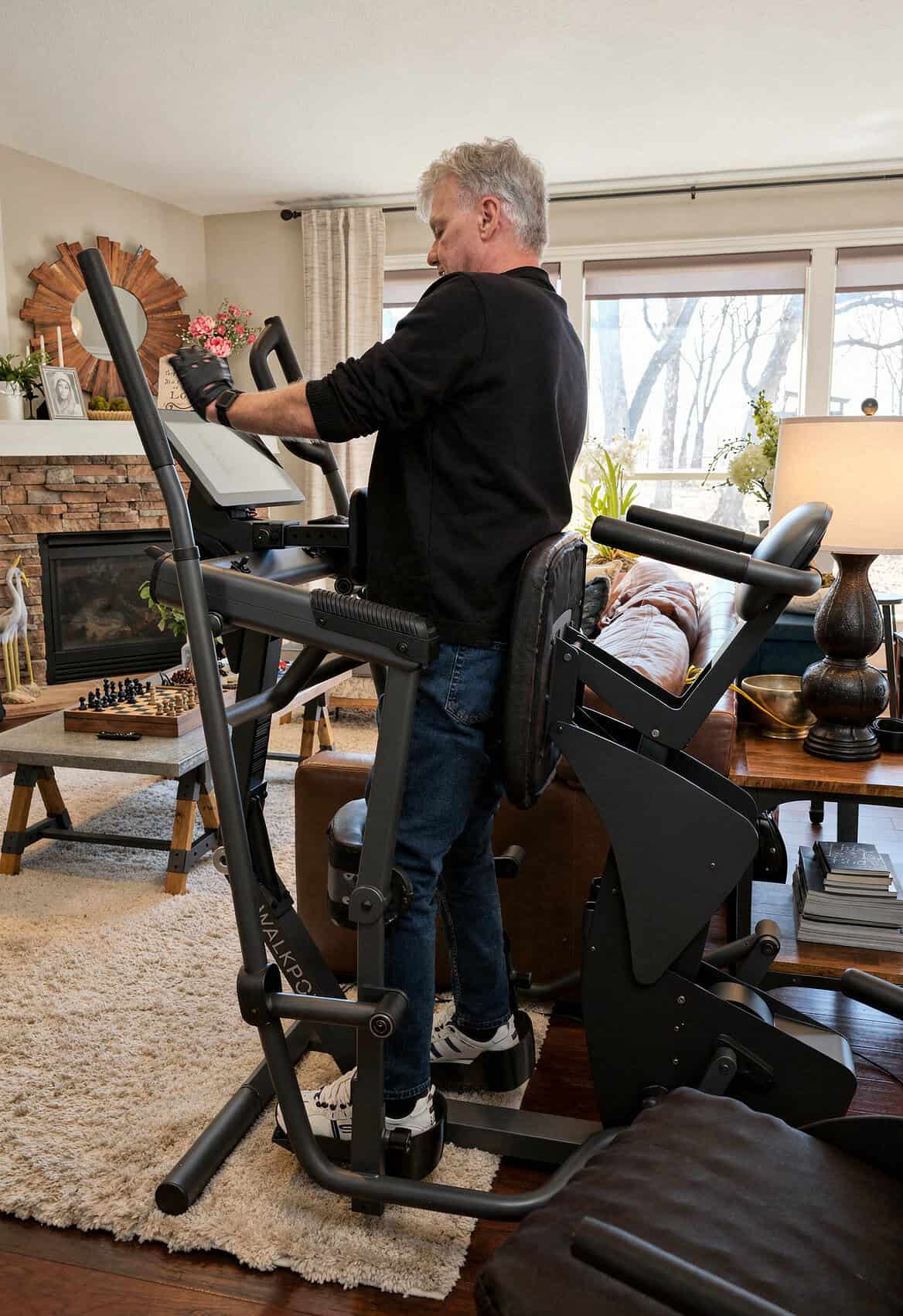Alan Tholkes, inventor of WalkPort, standing in a WalkPort Supported Walk Station at home