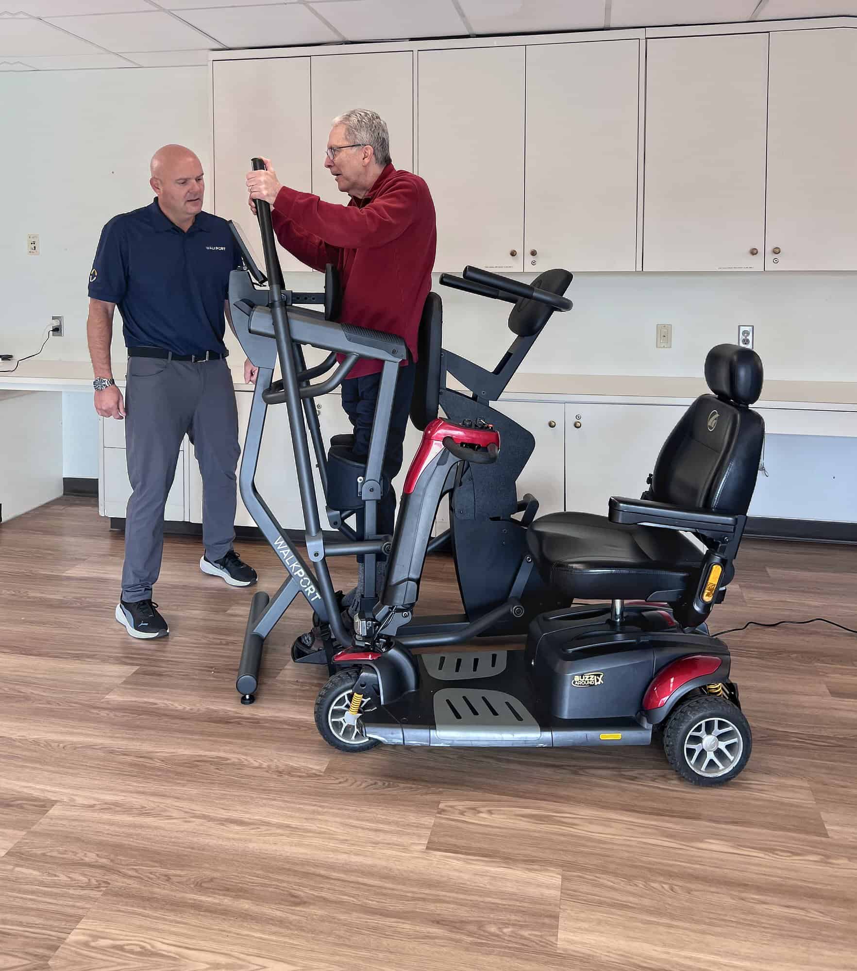 A guest tries WalkPort with a WalkThera team member beside him